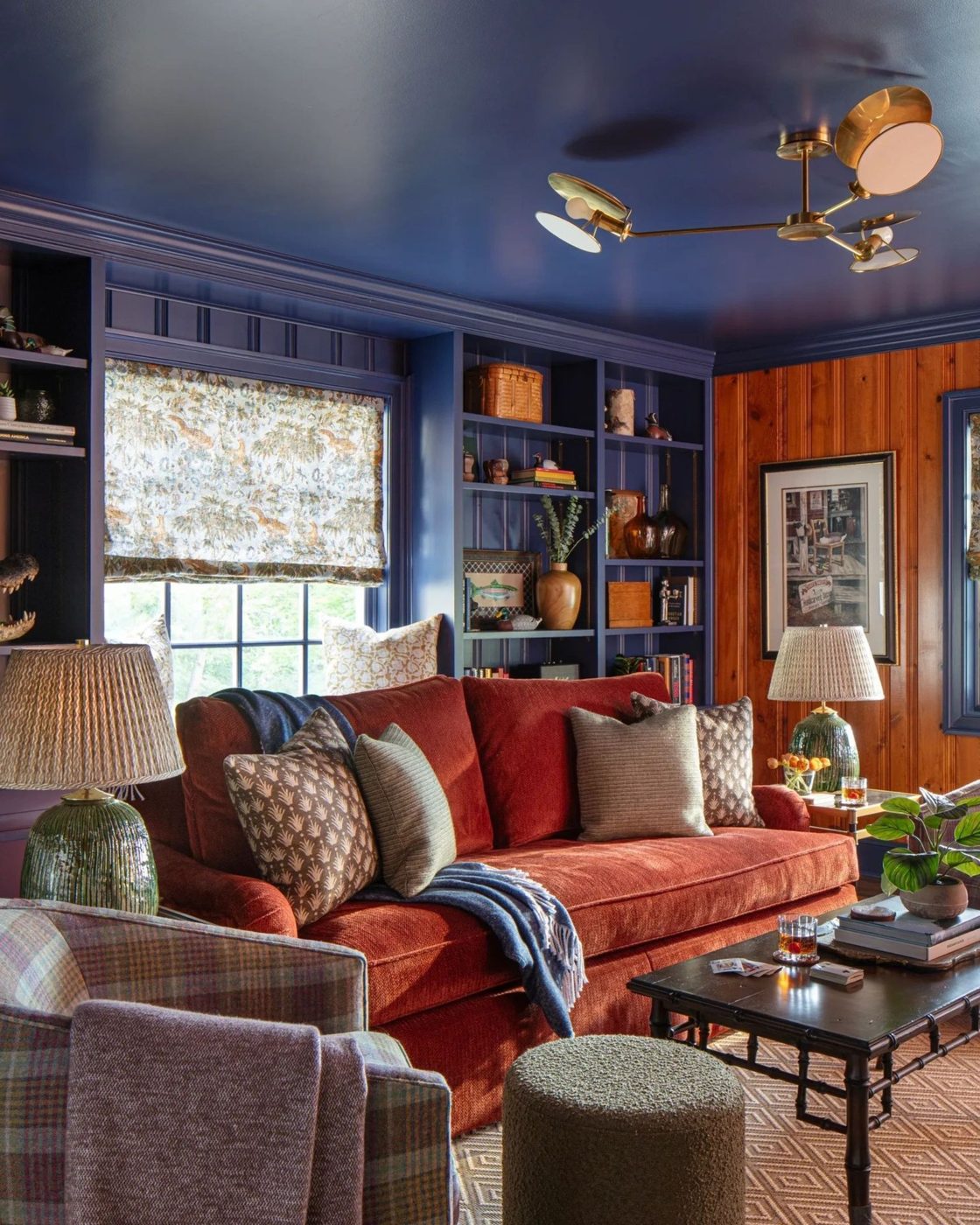 Navy library with painted ceiling and built-in shelving