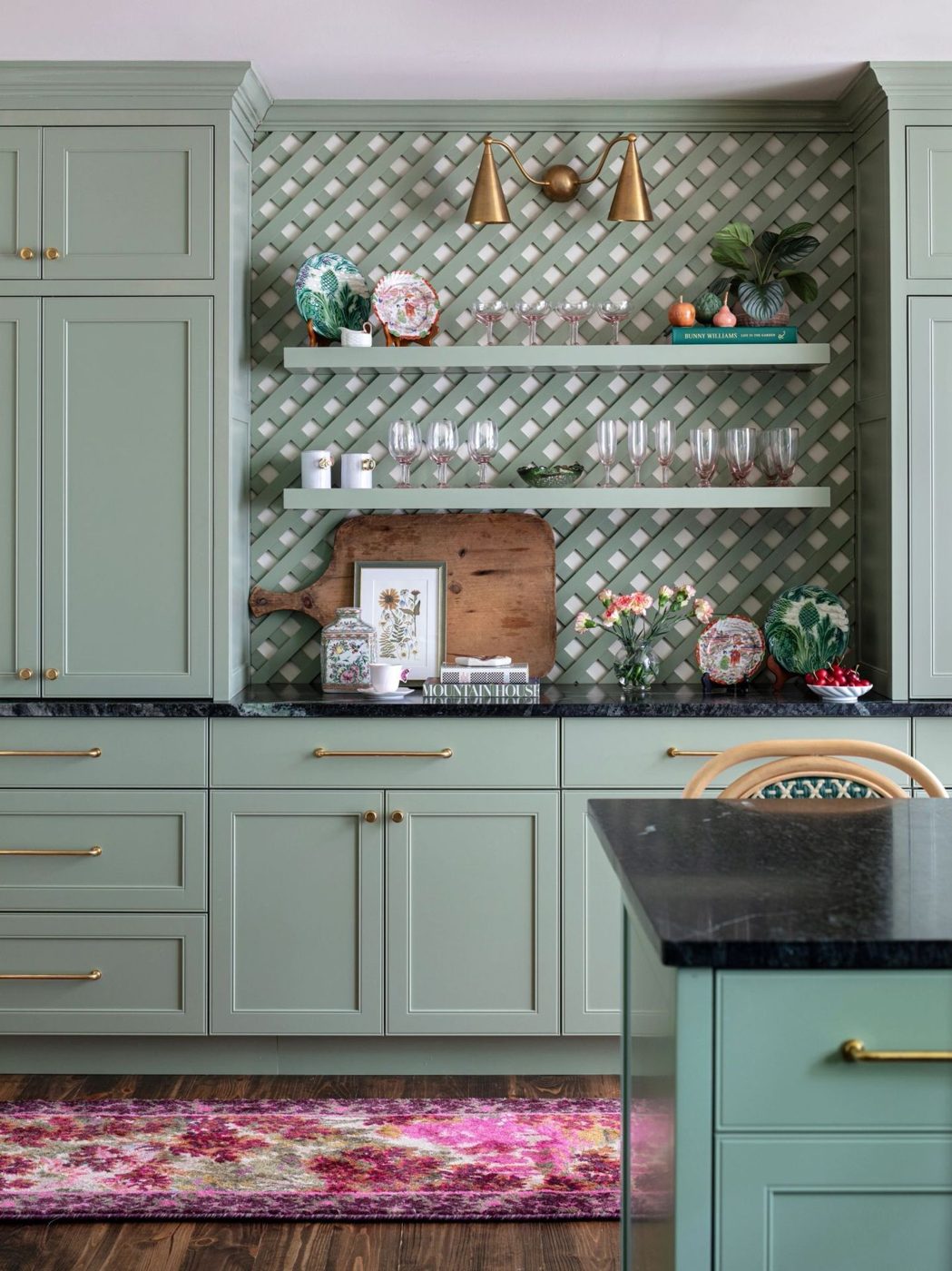 Sage green kitchen cabinets with brass hardware