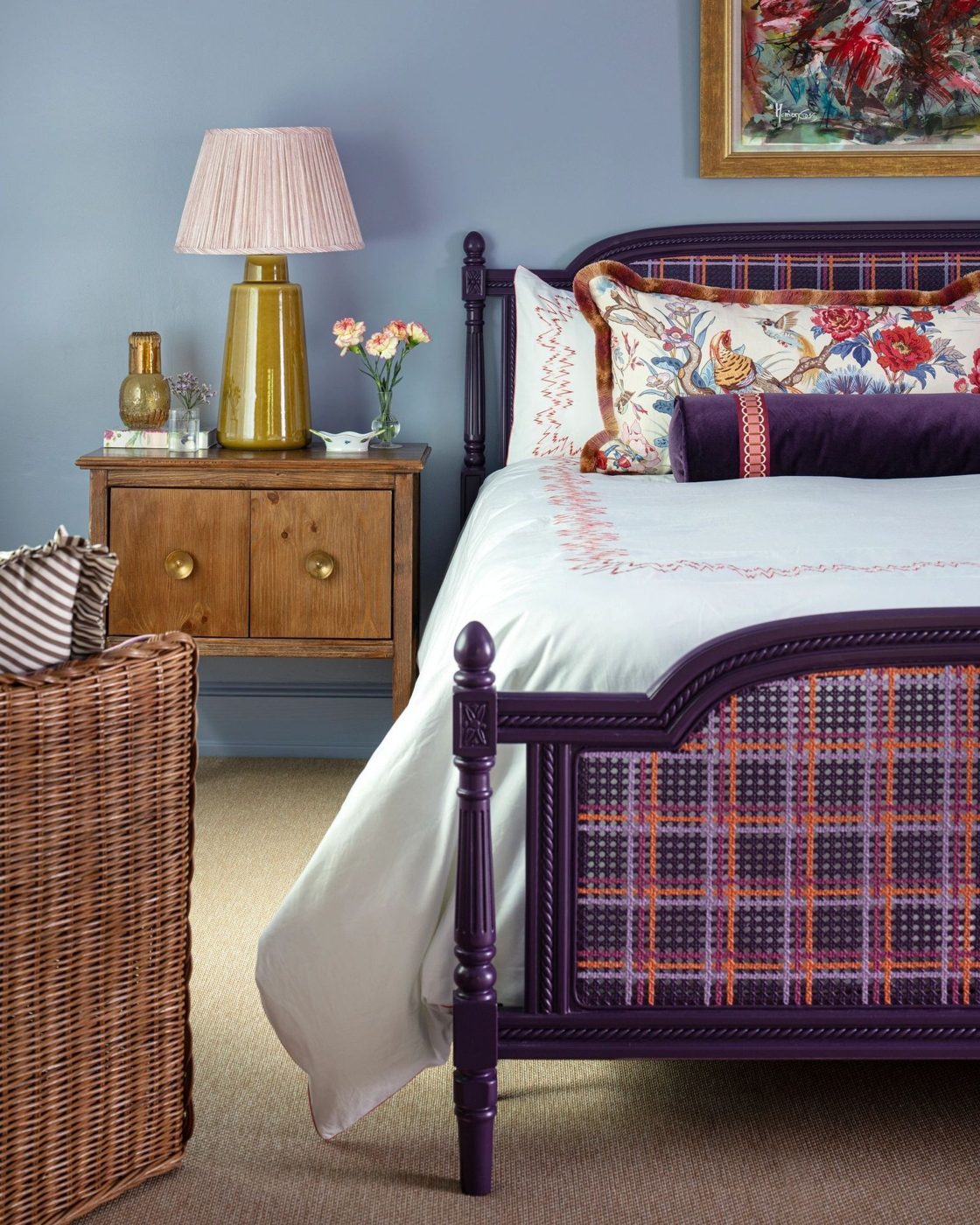 Bedroom with painted bed frame and soft blue walls