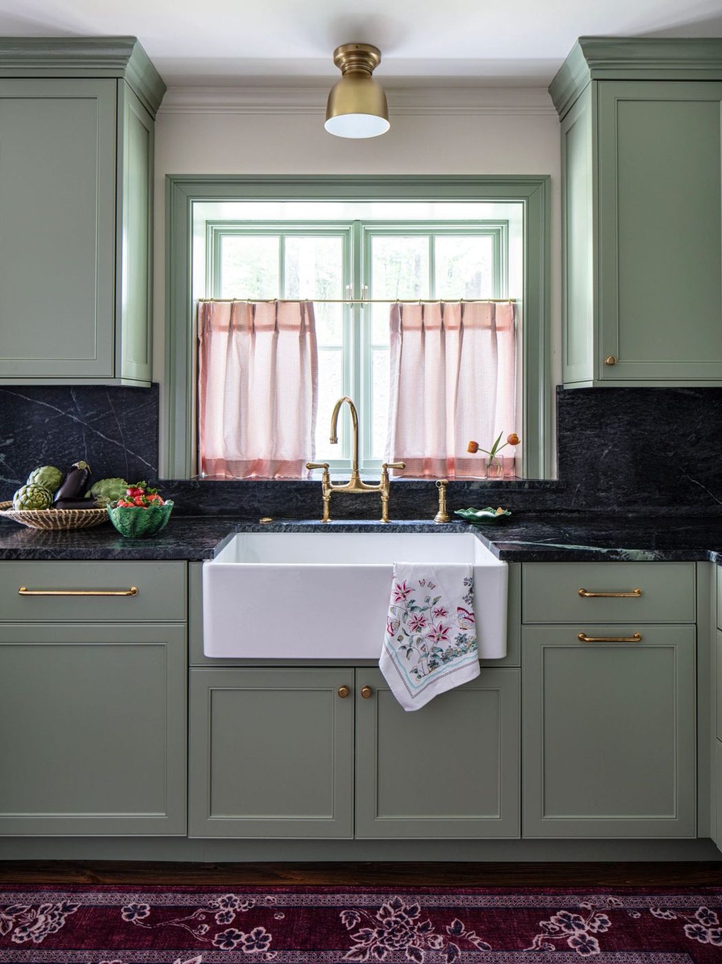 Green kitchen cabinets with farmhouse sink
