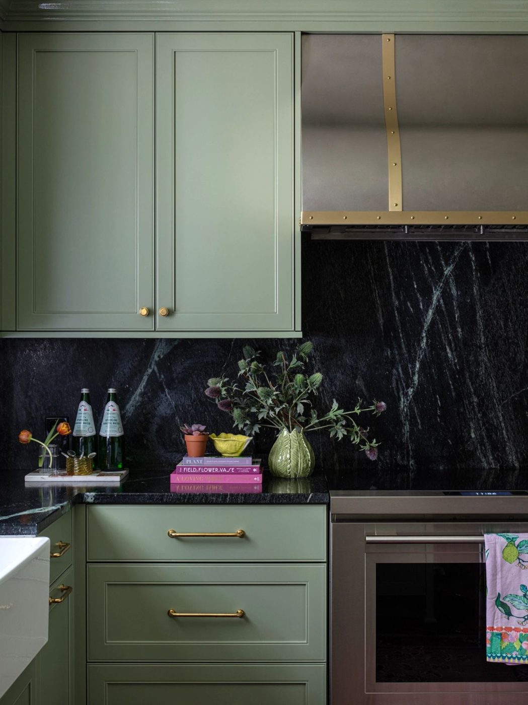 Painted kitchen cabinetry with marble backsplash