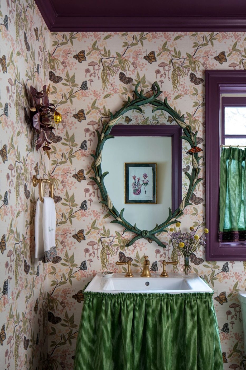 Powder room with wallcovering and plum trim
